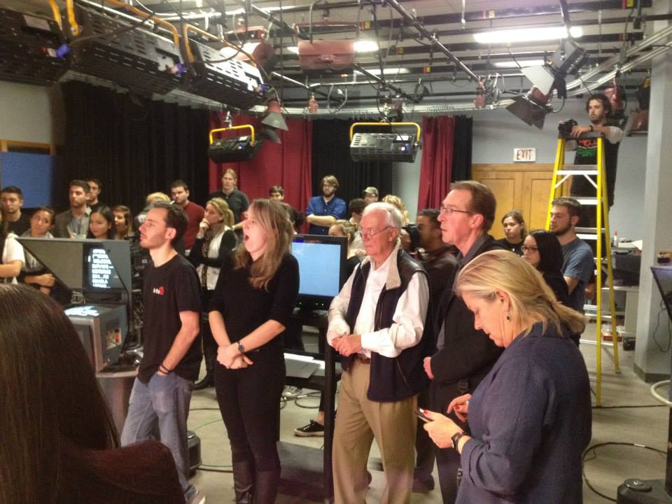 The large production team watches live coverage at the National Desk.