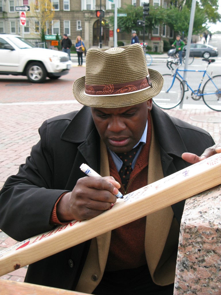 After donating to our fund raiser, Dean Elmore takes time to sign a piece of wood that will be part of our Dorchester Project home on Dacia Street.