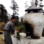 wangchuk, the driver, adding kindling to a roadside firepit. 