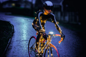 E9D994 Christmas Tree Cyclist with LED lighting at night.