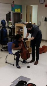 Kindergarteners try out the cello for the first time