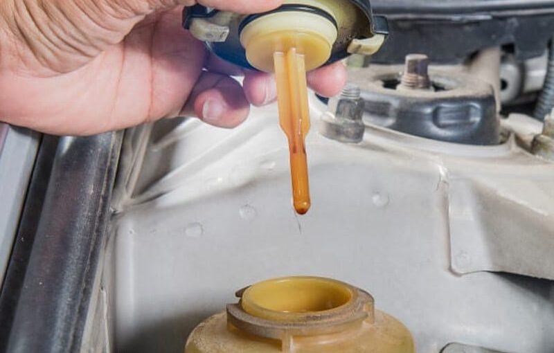 What does Milky hydraulic fluid mean?