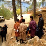 drivers keeping warm while guides and tourists hike.  the authorities told them they had to put out the fire. 
